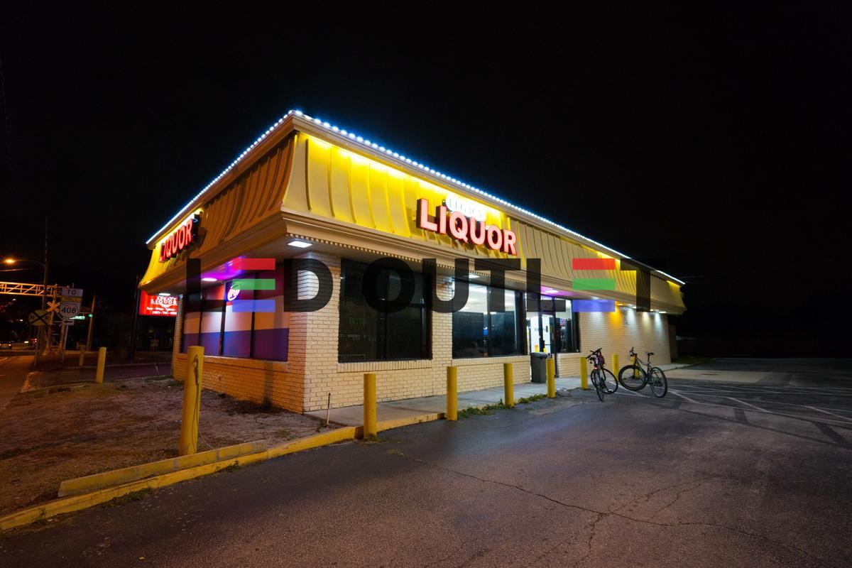 Liquor store roofline edge lit with LED at night, Orlando FL