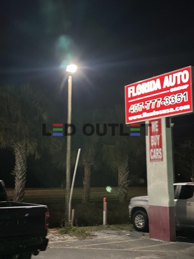 Florida Auto pylon sign lit at night