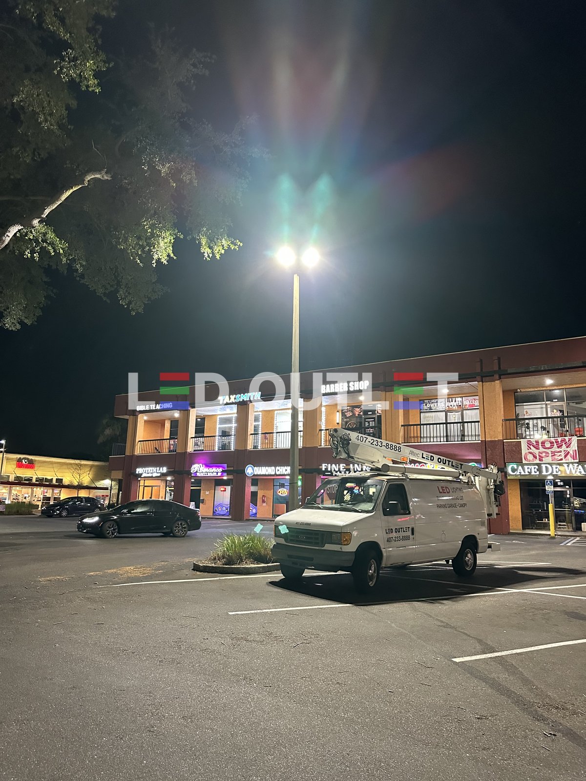 LED Outlet bucket truck servicing plaza parking lot lights